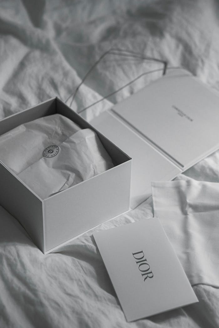 Monochrome photo of Dior packaging showcasing luxury and style.